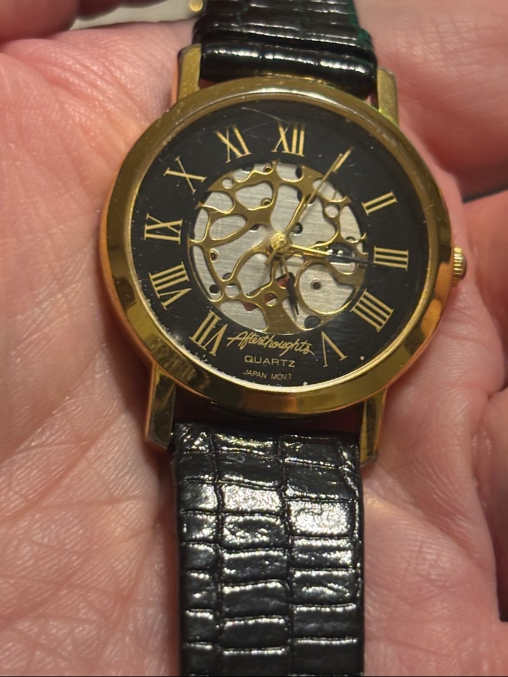 Women’s Gold and Black Skeleton Dial Watch